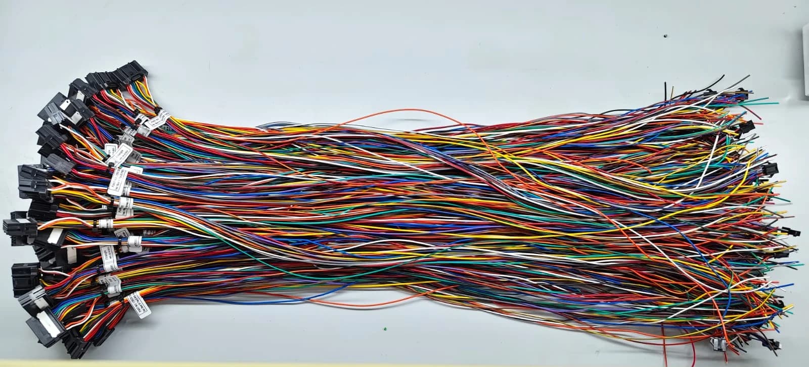 A large batch of multi-colour signal harnesses terminated in connectors.