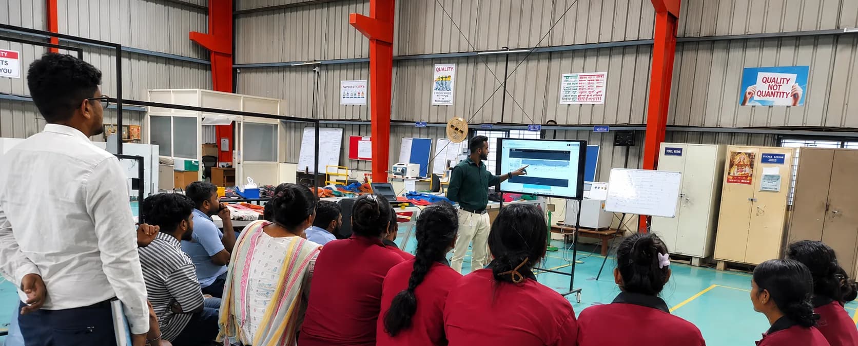 The MGTPL team in a daily quality huddle on the production floor.